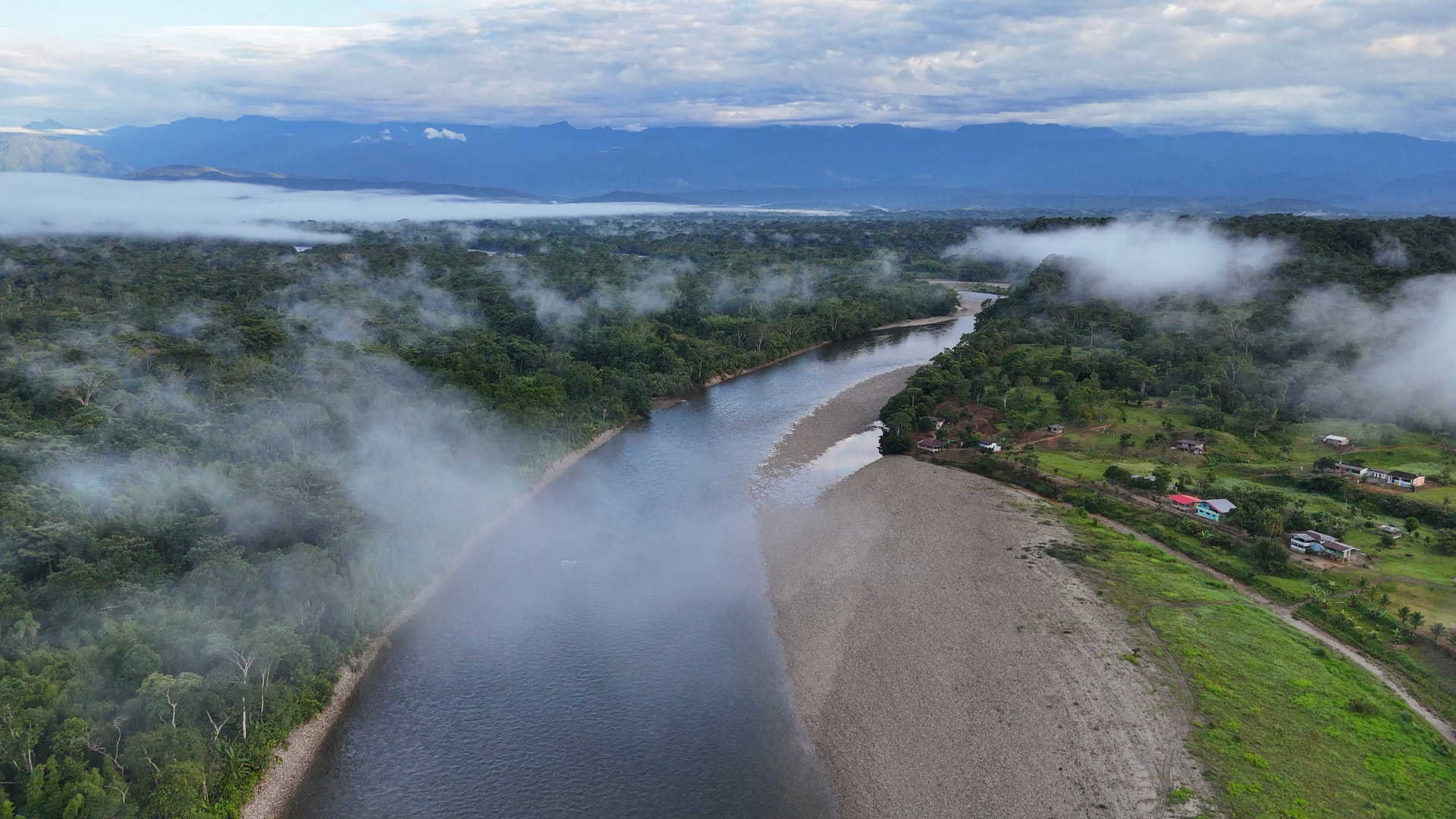 Aerial view of El Diviso along the river, mist rising over the Amazon