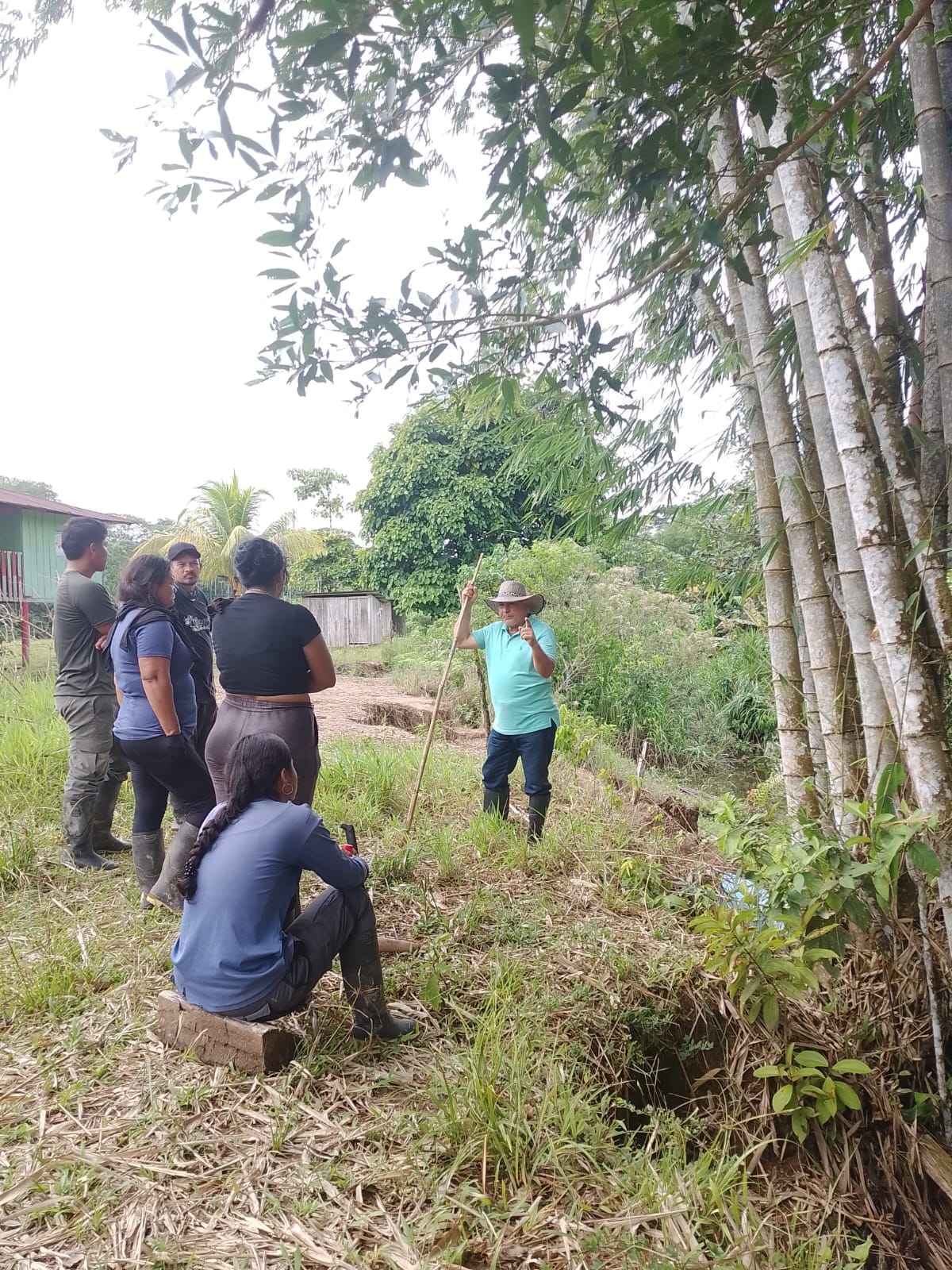 Technicians and community members working together in the field